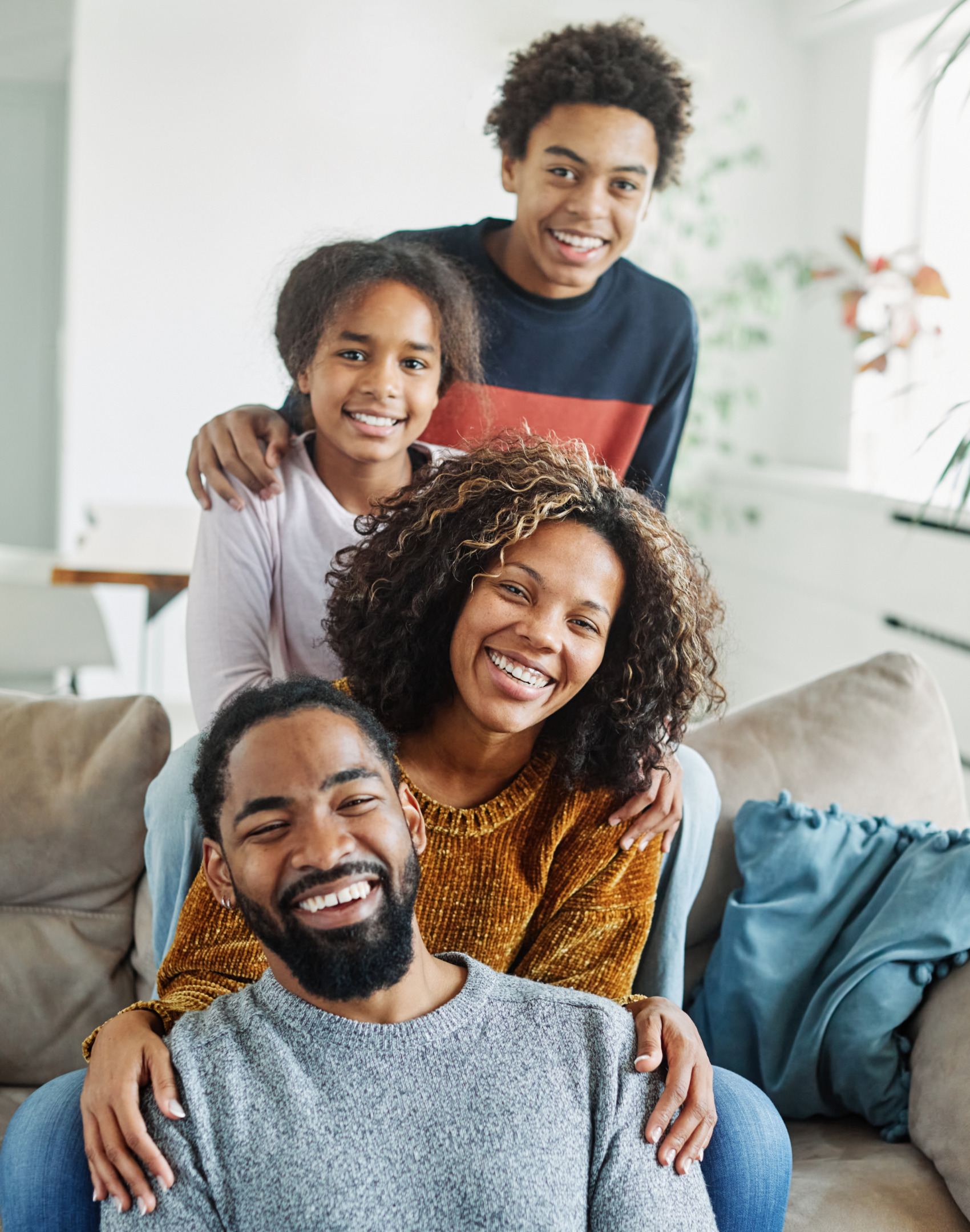 Smiling family embracing closely, symbolizing ConnectionPlus Care’s trauma-informed approach to family healing and resilience.