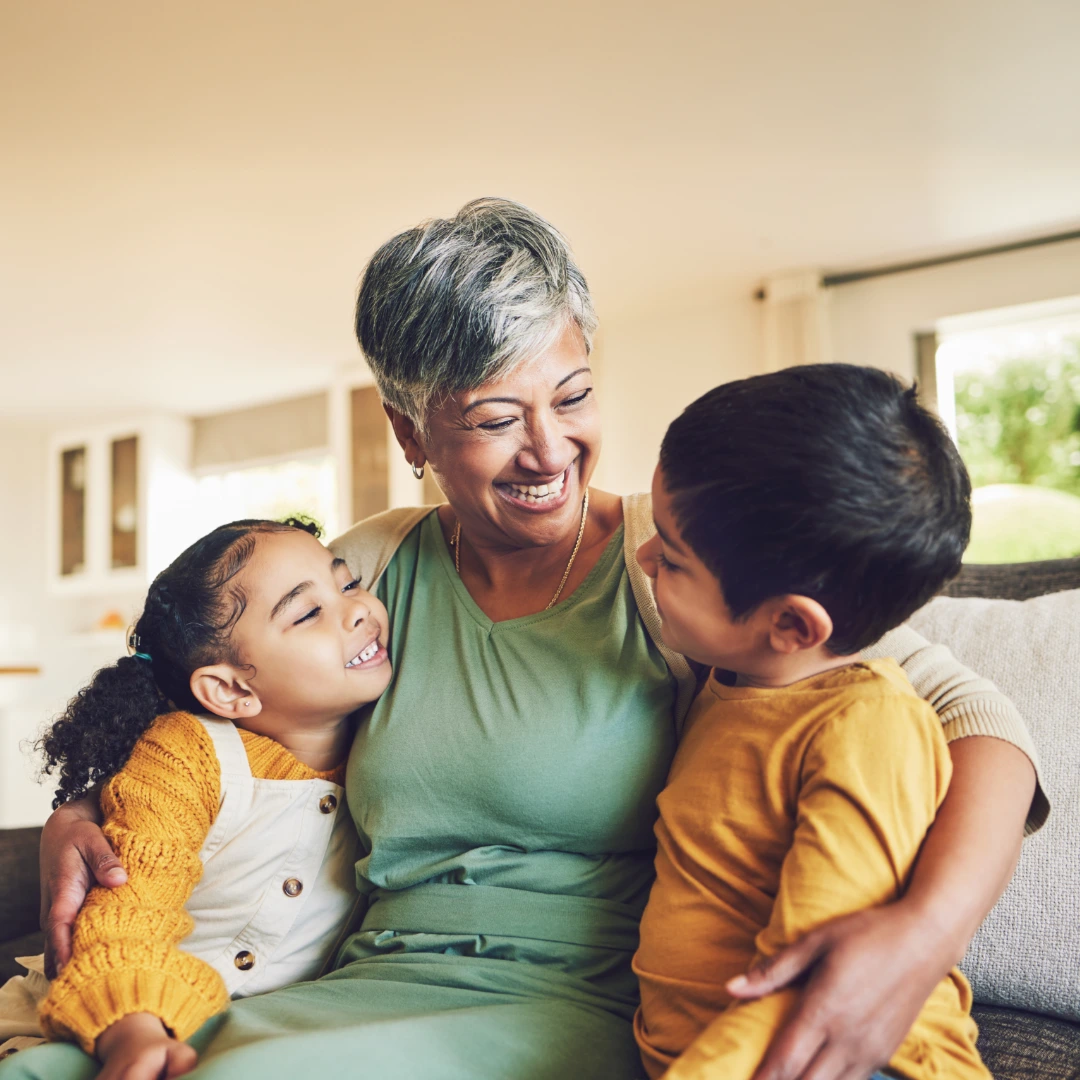 Parent and child share a supportive hug at home, representing connection, trust, and emotional safety after family coaching.