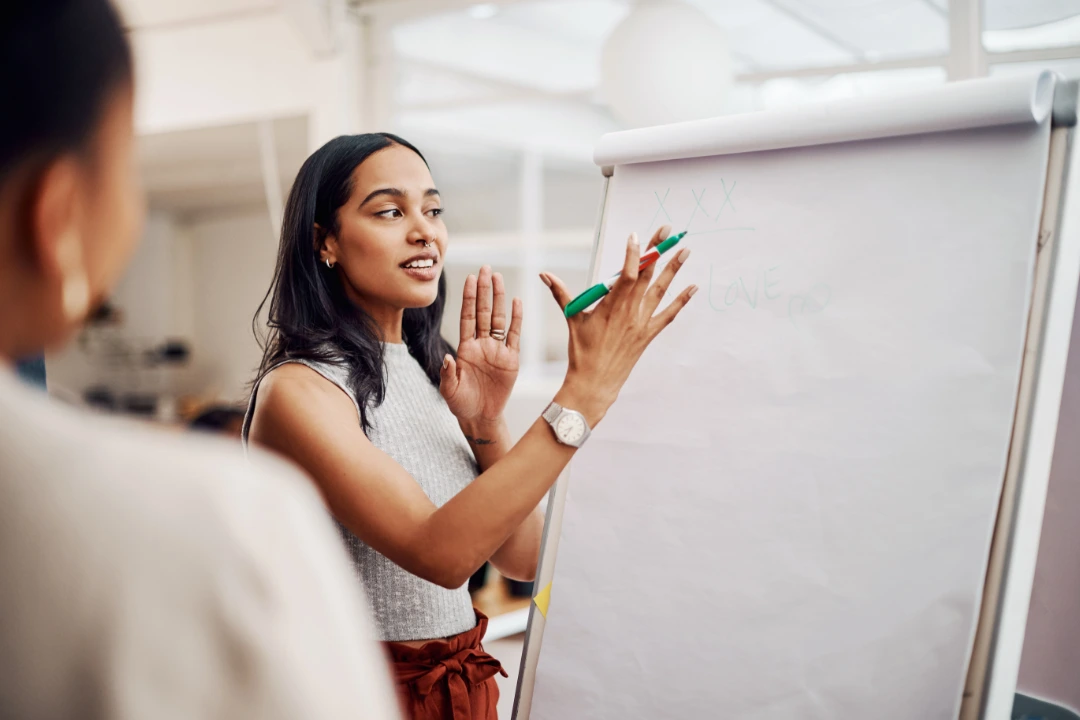 Trainer leading a small group session with caregivers, guiding discussion and sharing educational resources.