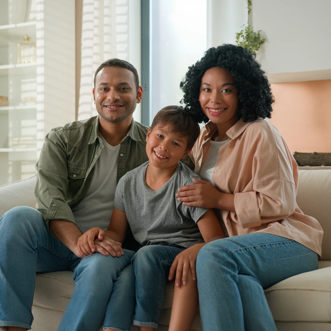 People sitting together on a sofa in a home setting, representing connection and personalized care solutions.